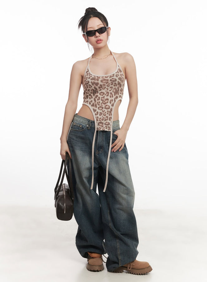 Leilani Washed Baggy Jeans CM531 in dark blue, full-body front shot on model, wide-fit washed denim pooling at hem, styled with leopard halter bodysuit and brown bag.