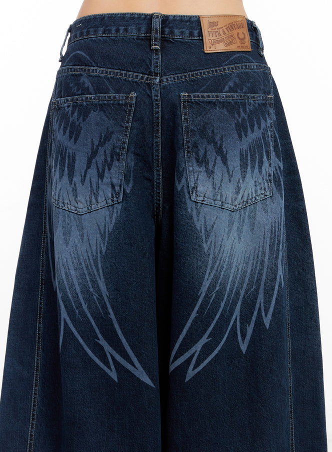 Sohee Angel Wing Print Wide-Leg Jeans IG508 in dark blue, back close-up detail showing angel wing print across dual pockets and leather brand patch at waistband.