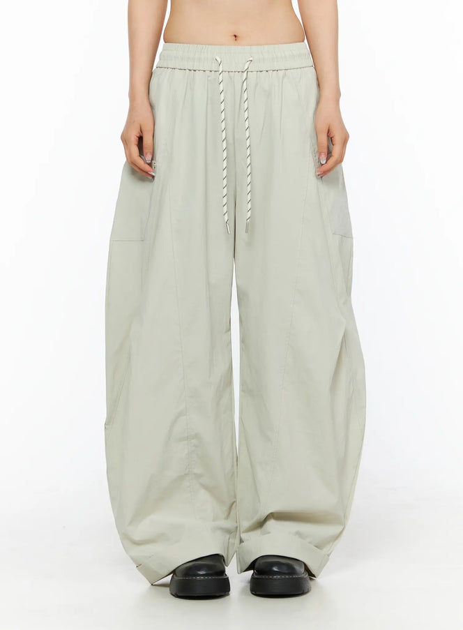 LEWKIN Wide Leg Cargo Pants CL501 Light beige front crop shot on model showing elastic drawstring waistband and wide-leg silhouette in lightweight fabric